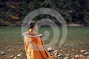 woman walking in the autumn forest near the river travel