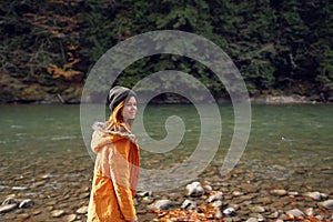 woman walking in the autumn forest near the river travel