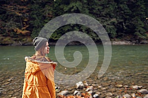 woman walking in the autumn forest near the river travel