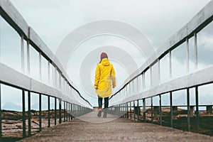 Woman walking away on bridge road Travel Lifestyle emotional concept vacations outdoor