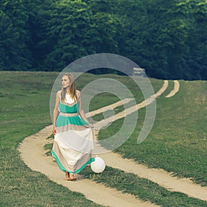 Woman walking with balloon in hand