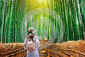 Woman walking at Bamboo Forest in Kyoto, Japan