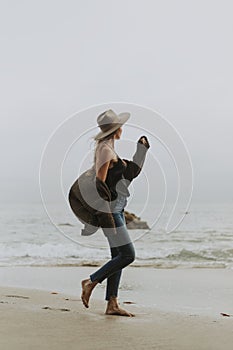 Woman walking barefoot at the beach