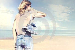 Woman walking barefoot on the beach in freedom