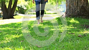 Woman walking barefoot on the grass