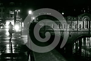 Woman walking in Bath on a rainy night