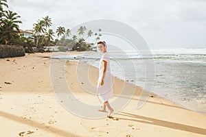 Woman walking on the beach sand