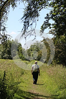 Woman walking on canal towpath Cumbria countryside