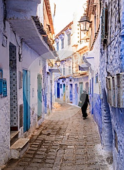 Woman walking in Chefchaouen, Morocco