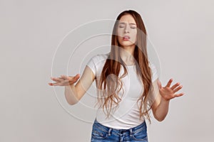 Woman walking with closed eyes, stretching hands to search way in darkness, vision problems.