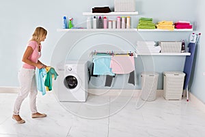 Woman Walking With Clothes In Utility Room