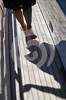 Woman walking on the deck of a yacht