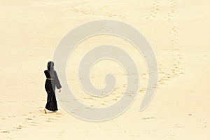 Woman walking by desert routes photo
