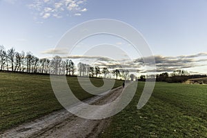 A woman walking on a dirt road