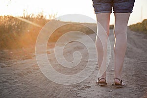 Woman walking on the dirt road