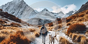 Woman Walking Dog Down Beautiful Mountain Path in Autumn Winter With Snowy Peaks Outdoors