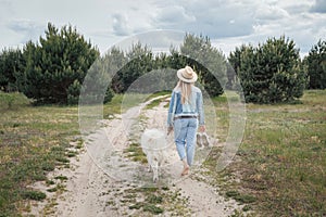 Woman walking with dog on nature out of city