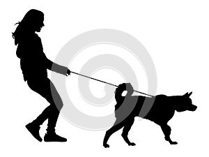 Woman walking with dog silhouette.