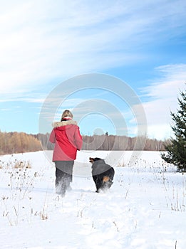 Woman walking with dog in snow