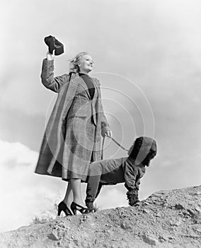 Woman walking dog on windy day