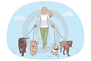 Woman walking with dogs on leashes
