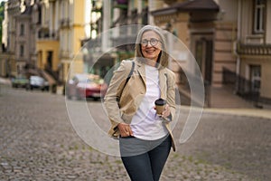 Woman Walking Down Cobblestone Street