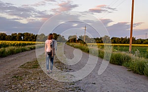 Woman walking down a country road