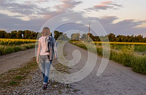 Woman walking down a country road