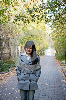 Woman walking down a road