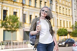 Woman Walking Down Street With Drink