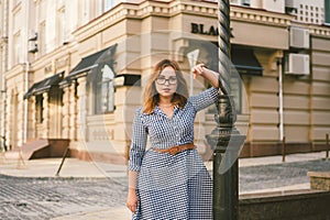 Woman walking in dress in old city. Fashion Style Photo Of A Young Girl. happy stylish woman at old european city street
