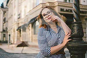 Woman walking in dress in old city. Fashion Style Photo Of A Young Girl. happy stylish woman at old european city street