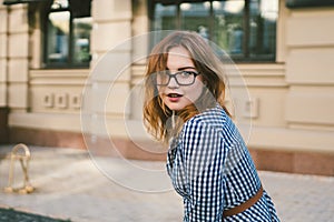 Woman walking in dress in old city. Fashion Style Photo Of A Young Girl. happy stylish woman at old european city street