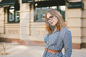 Woman walking in dress in old city. Fashion Style Photo Of A Young Girl. happy stylish woman at old european city street