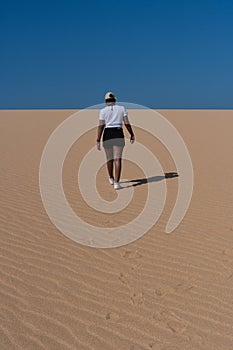 Woman walking in the dunes of Taroa in La Guajira, Colombia