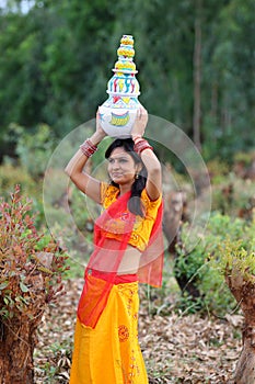 Woman walking with earthen pots