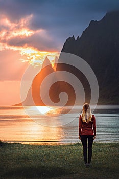 Woman walking on Ersfjord beach in Norway travel solo harmony with nature healthy lifestyle