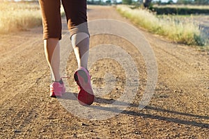 Woman walking exercise on trail in summer nature