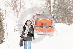 Woman walking with gas can winter car