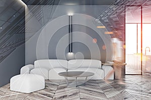 Woman walking in gray living room with white sofa
