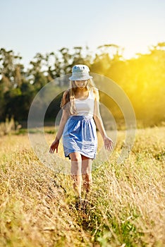 Woman, walking and happiness in nature for field, travel and adventure in countryside for spring. Gen z, smile and