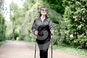 Woman walking with hiking sticks