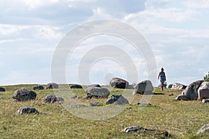 Woman walking through a historical grave field