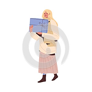 Woman walking with holiday gift box. Happy female going and carrying Christmas present. Person holding festive winter