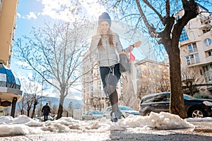 Woman walking through melting snow in late winter
