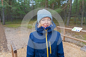 Woman walking in nature park in cold weather. Female outdoor. Cold weather