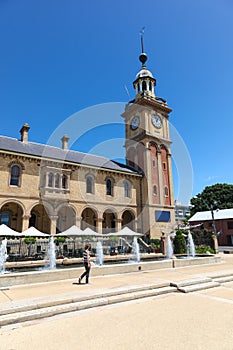 Woman walking in Newcastle past Customs House