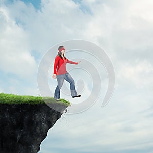 Woman walking off cliff