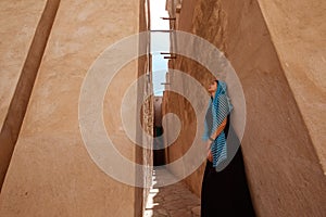 Woman walking in old Dubai city, UAE