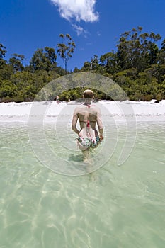 Woman walking out of lake